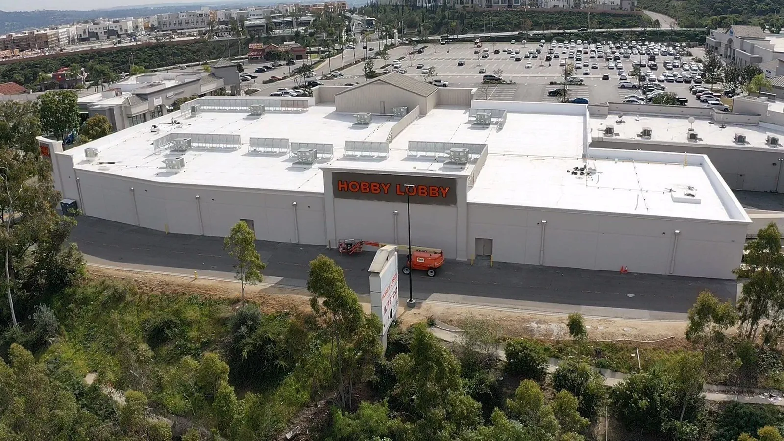 Drone view of a white single-ply roof on a Hobby Lobby retail building