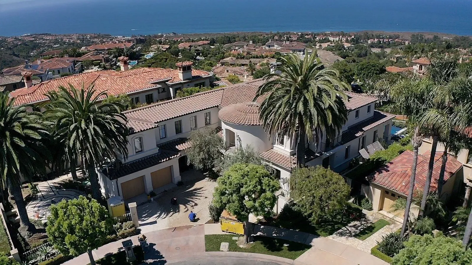 Aerial view of clay tile roofs on custom homes near the coast